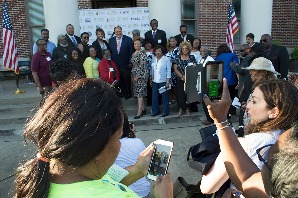 group gathered taking photos of group on courthouse steps